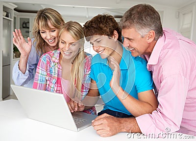 Family using laptop at home Stock Photo