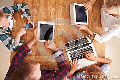 Family using new technology, overhead view Stock Photo