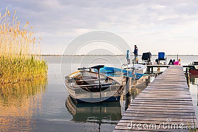 Family vacation at Lake Balaton, Fishing together, Boats, Setting sun, Hungary, Lake Balaton, May 1, 2023 Editorial Stock Photo