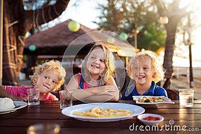 Family vacation lunch. Kids in beach restaurant Stock Photo