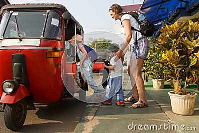 Family on vacation, mother and kids getting in a tuk-tuk, having fun Stock Photo