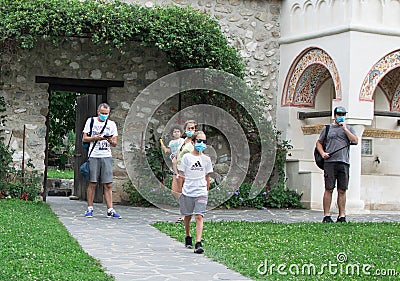 Family on vacation during the pandemic. Family with medical masks visits tourist attractions Editorial Stock Photo