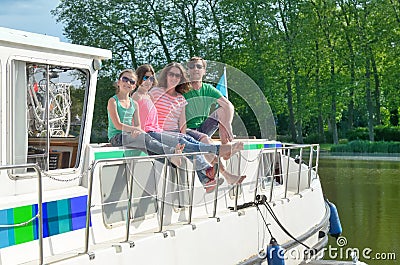 Family vacation, summer holiday travel on barge boat in canal, happy kids and parents having fun on river cruise trip in houseboat Stock Photo