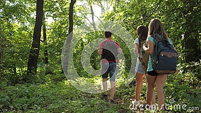 Family on vacation travels in forest. dad and daughters, children travel in park in summer. friends-tourists go camping Stock Photo