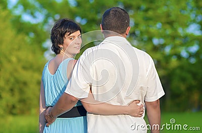 Family Values Concepts and Ideas. Two Caucasian Mature Adults Enjoying Together Outdoors. Walking Embraced in Park Stock Photo