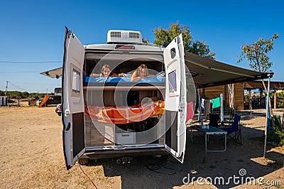 Family waking up in a campervan on the beach Stock Photo
