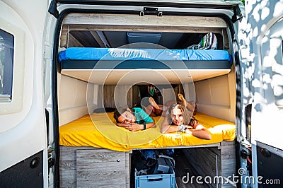 Family waking up in a campervan in the camping campsite Stock Photo