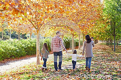 Family walking in an autumn park Stock Photo