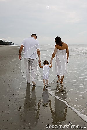Family Walking on the Beach Editorial Stock Photo