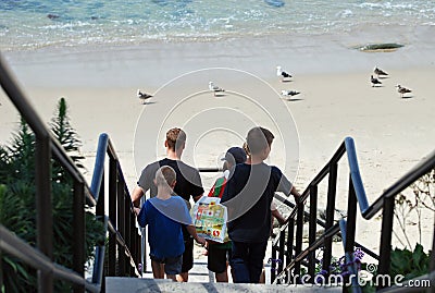 Family walking down stairs to beach in Laguna Beach, California. Editorial Stock Photo
