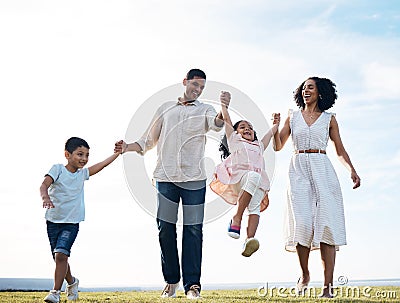 Family, walking and holding hands outdoor at a park with love, care and happiness together in nature. Young man and Stock Photo