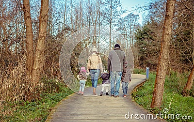 Family walking together holding hands in the Stock Photo