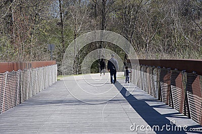 A Family walks over the Wolf River Bridge Editorial Stock Photo