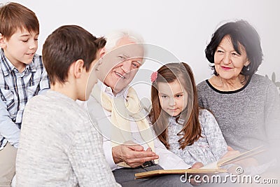 Family watching photo album Stock Photo