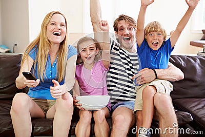Family Watching Soccer on TV Celebrating Goal Stock Photo