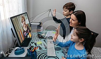 Family waving on video call with grandmother Stock Photo