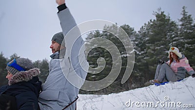 Family Weekend, Happy Father with Sons and Wife Have Fun Sledding in ... image