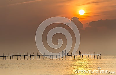 Family welcome sunrise on wooden bridge Editorial Stock Photo