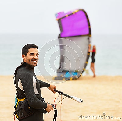 Family in wetsuits with surf boards Stock Photo