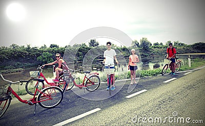Family with young boys and little girl with bike on the road Stock Photo