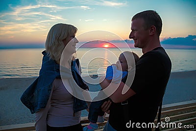 Family with a young child on the shore of the Baltic Sea Stock Photo