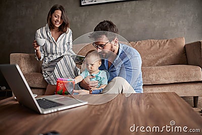Family - Couple spending happy time at home with their baby son Stock Photo