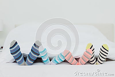 Familys feet in stripey socks Stock Photo