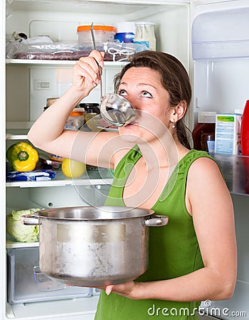 Famished woman on a diet eating Stock Photo