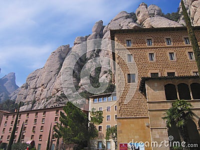 Famous Benedictine monastery of Montserrat with cliffs and blue sky at the background in Montserrat, Spain. Editorial Stock Photo