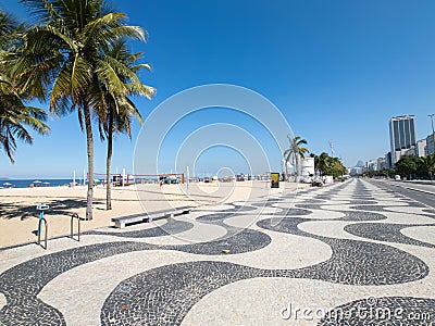 Famous Boardwalk on Copacabana Beach and coconut trees with blue sky in Rio de Janeiro Brazil Stock Photo