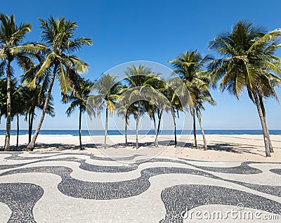 Famous Boardwalk on Copacabana Beach and coconut trees with blue sky in Rio de Janeiro Brazil Stock Photo