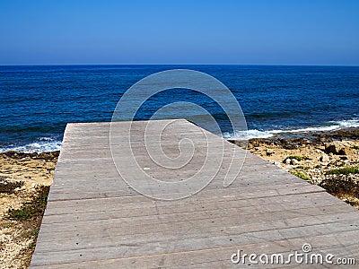 Famous coastal broadwalk path surrounding the archaeological park Paphos Cyprus Stock Photo