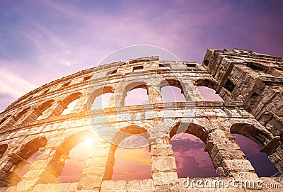 Famous Croatian city Pula old amphitheater arches with sunset sk Stock Photo