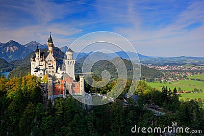 Famous fairy tale Neuschwanstein Castle in Bavaria, Germany, late afternoon with blue sky with white clouds Stock Photo