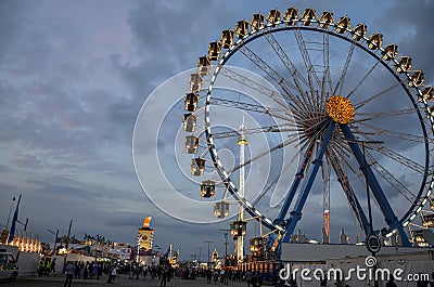 Famous ferris wheel and main street on Theresienwiese at the Oktoberfest in Munich, Bavaria Editorial Stock Photo