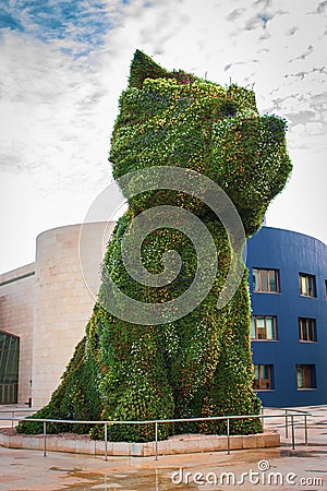 Famous giant flower dog near Guggenheim Museu in Bilbao. Floral guard dog called Puppy with blooming flowers. Bilbao landmark. Editorial Stock Photo
