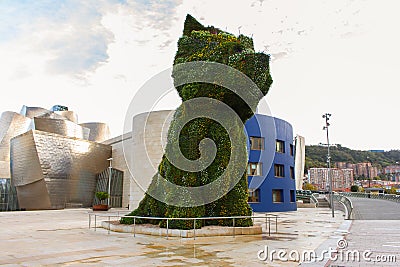 Famous giant flower dog near Guggenheim Museu in Bilbao. Floral guard dog called Puppy with blooming flowers. Bilbao landmark. Editorial Stock Photo