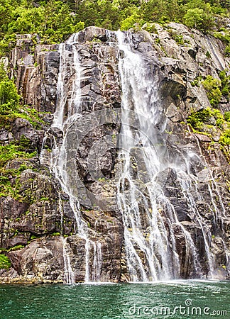 Famous Hengjanefossen waterfall coming down from a steep rock face into Lysefjord. Stock Photo