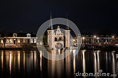 The famous historical `Waterpoort` in the city of Sneek at night with reflections in the canal - Sneek, Friesland, The Netherlan Editorial Stock Photo