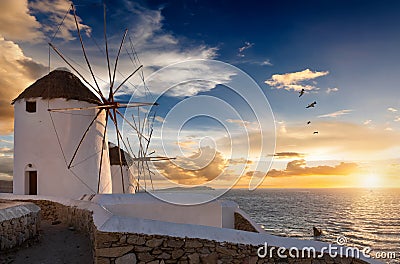 The famous Mykonos windmills during sunset, Greece Stock Photo
