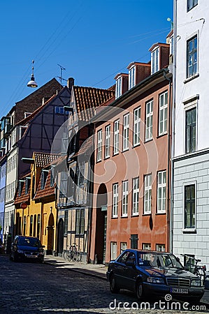 Famous narrow street with colourful buildings in Copenhagen`s old historic center Editorial Stock Photo