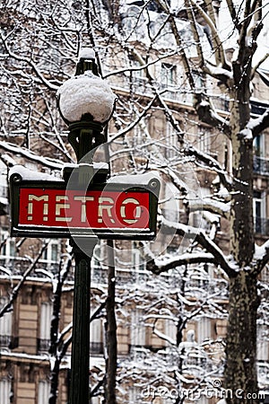 Famous Parisian metro sign after snowfall, France Editorial Stock Photo