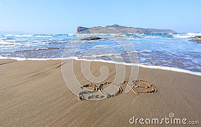 Famous resort of Crete island, Greece. Sand beach seascape with the rays of the sun. 2019 writing on the surface. Beautiful sea Stock Photo
