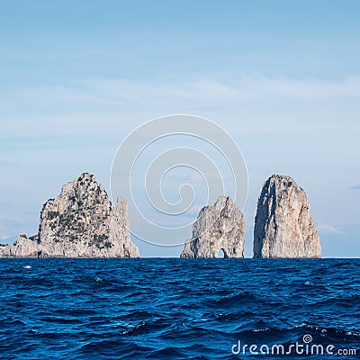 Famous sea stacks with arch, faraglioni, off the coast of Capri in the Bay of Naples on the Mediterranean Sea, Italy. Stock Photo