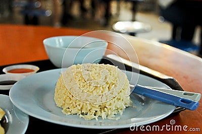 Famous Singaporean Hainanese Chicken rice with soup in a food court hawker center served in blue plate Stock Photo