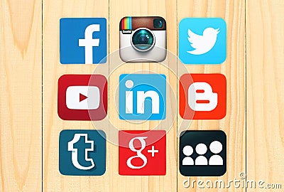 Famous social media icons placed on wooden background. Editorial Stock Photo