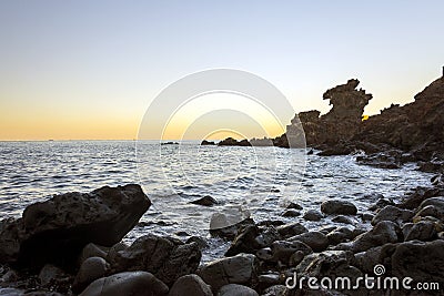 Famous tourist attraction in Jeju island of South Korea. View of Yongduam also known as dragon head rock during sunset. Stock Photo