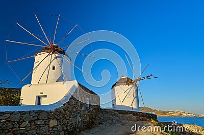 Famous tourist attraction, Mykonos, Greece. Two traditional whitewashed windmills. Summer, morning, clear blue sky Stock Photo