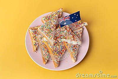 The famous traditional Australian food Fairy Bread on a yellow background Stock Photo