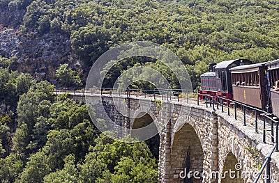 The famous train of Pelion makes its route in the mountains Greece Editorial Stock Photo